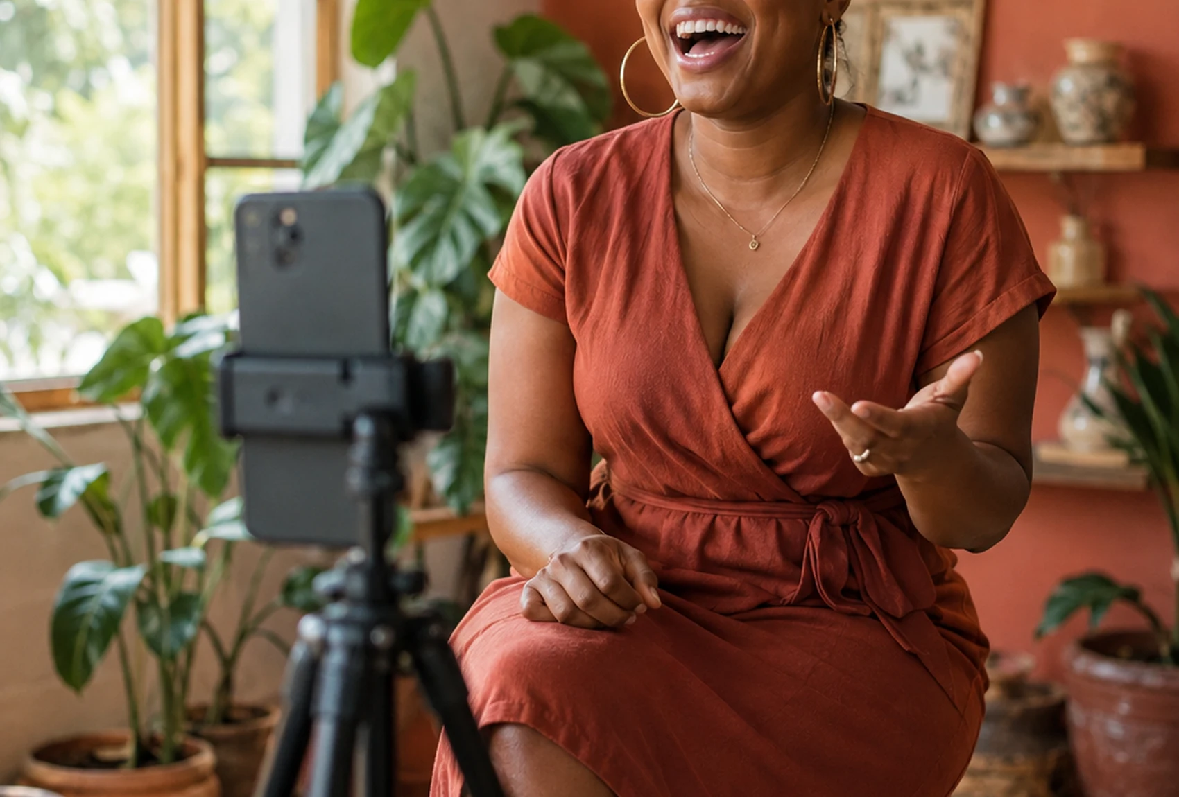 A Zimbabwean media personality recording a video greeting on a phone mounted on a tripod